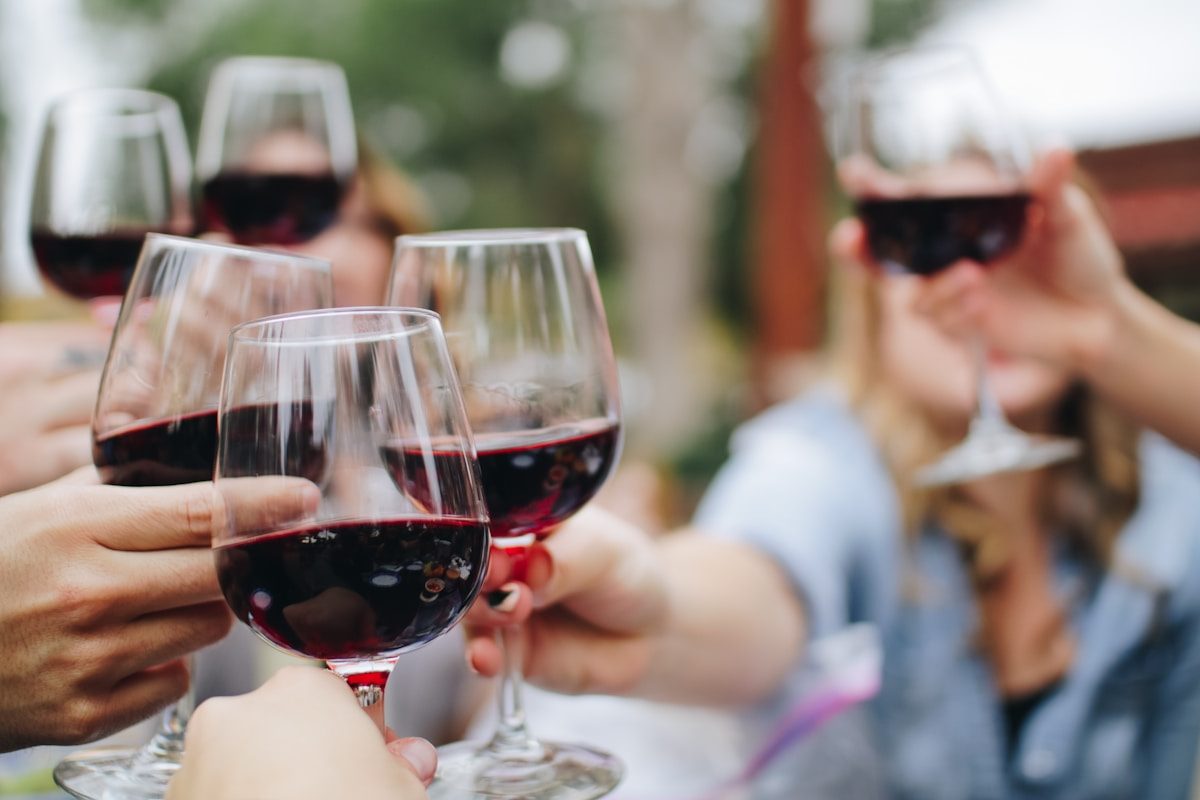 Red wine poured into a glass at a private dinner table
